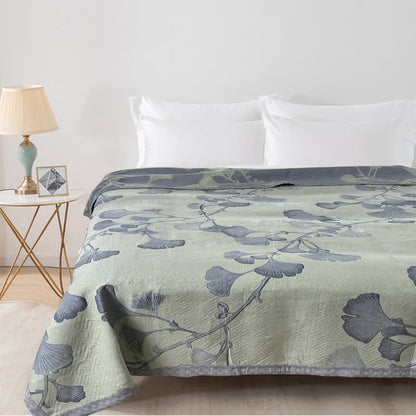 Reversible cotton gauze blanket with ginkgo leaf pattern and border, breathable for summer and transitional seasons