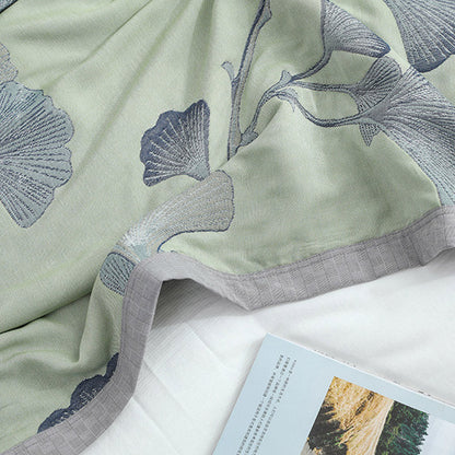 Reversible cotton gauze blanket with ginkgo leaf pattern and border, breathable for summer and transitional seasons