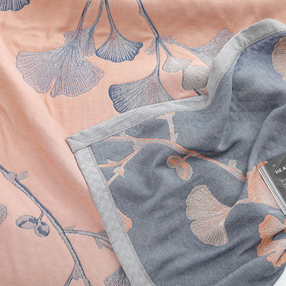 Reversible cotton gauze blanket with ginkgo leaf pattern and border, breathable for summer and transitional seasons