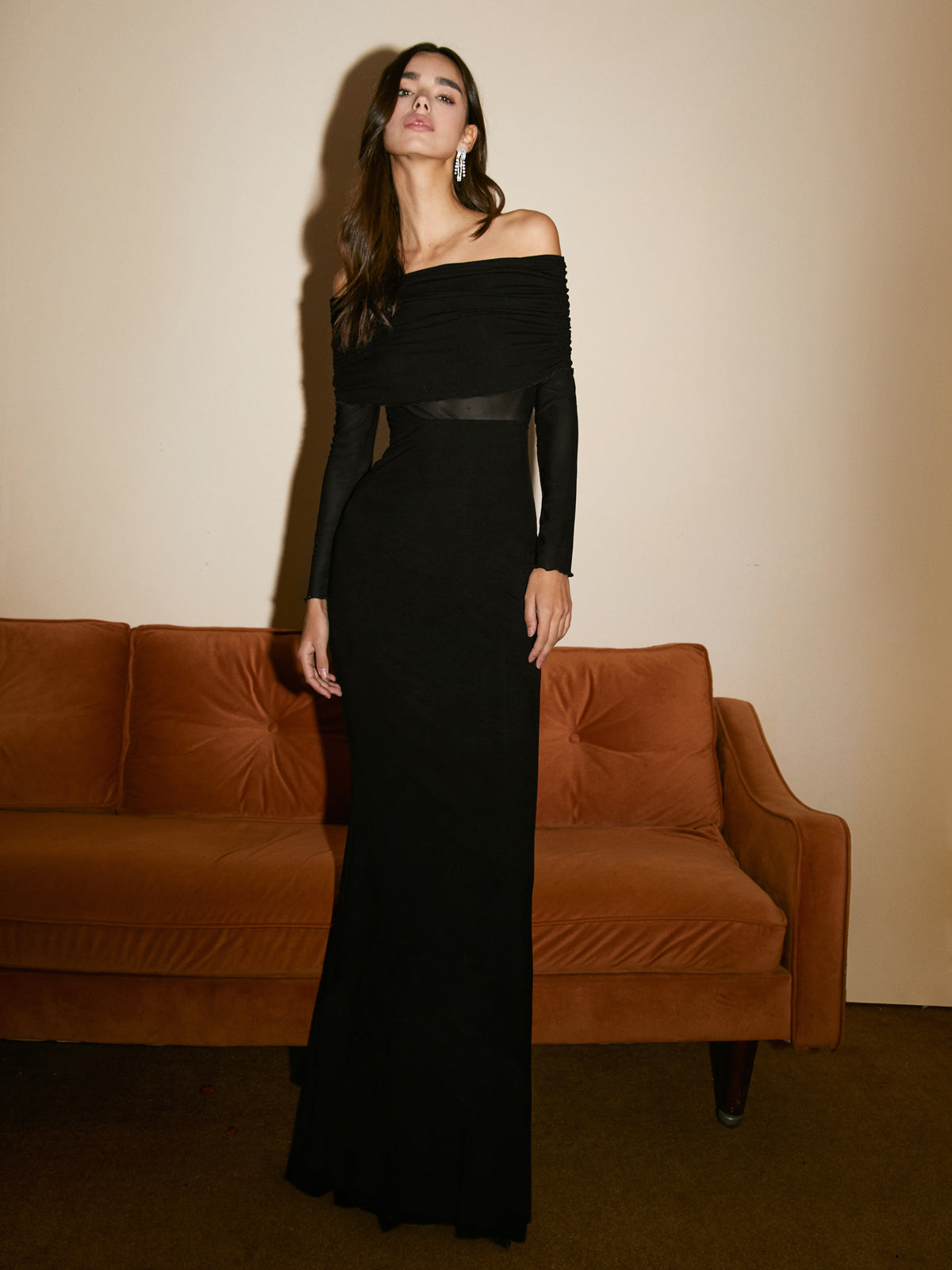 Floor-length women's evening dress with off-the-shoulder neckline, long sleeves, and gathered bust