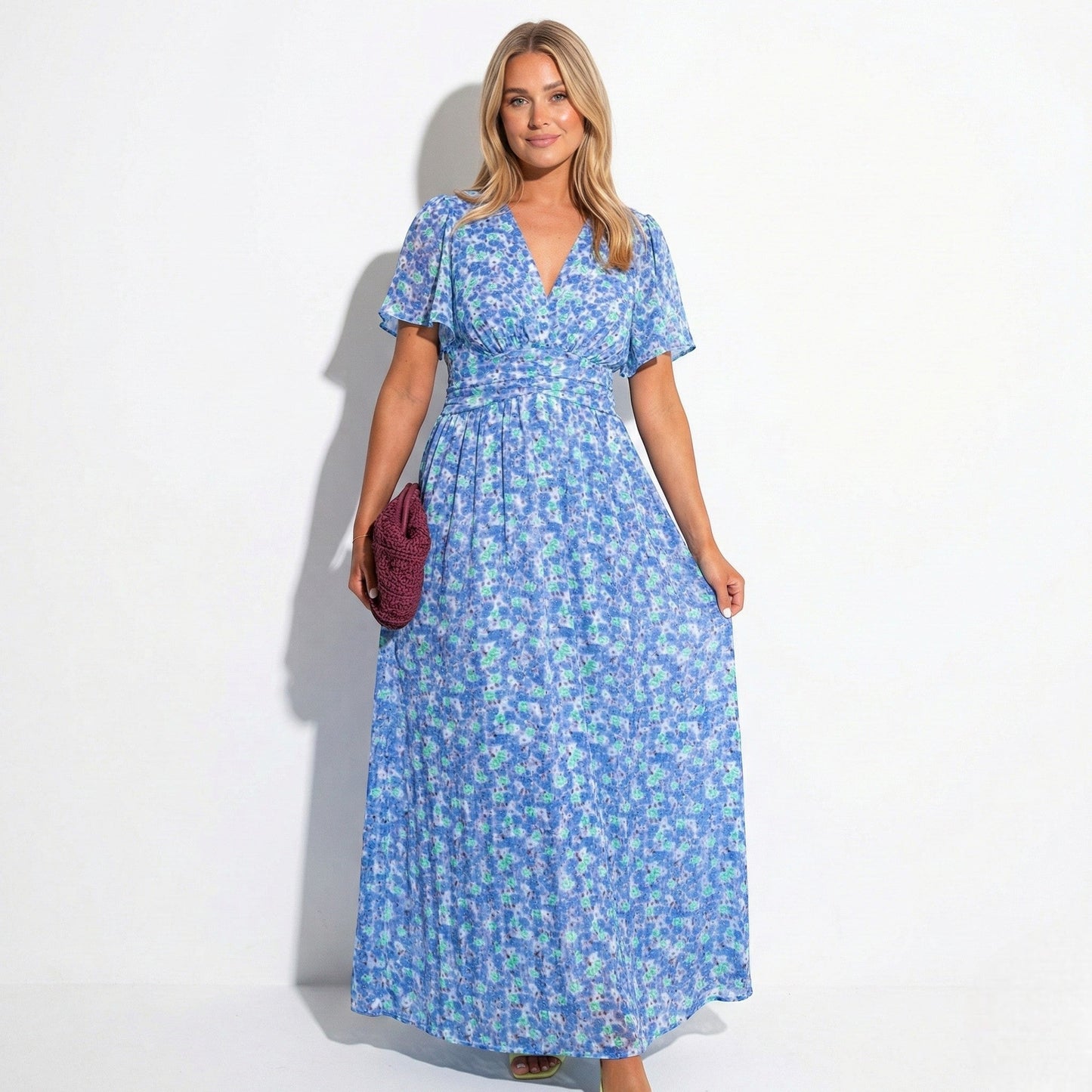 Women's maxi dress with V-neck, floral pattern, and flutter sleeves