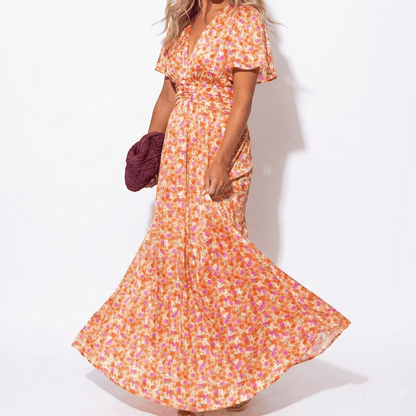 Women's maxi dress with V-neck, floral pattern, and flutter sleeves