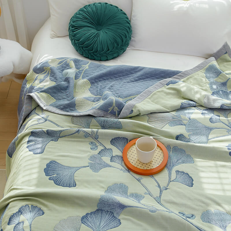 Reversible cotton gauze blanket with ginkgo leaf pattern and border, breathable for summer and transitional seasons